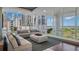 Modern living space featuring floor-to-ceiling windows with views of both the city and bay, plus sleek furnishings at 175 1St S St # 3008, St Petersburg, FL 33701