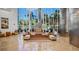 Grand lobby featuring elegant seating, stylish decor, and impressive floor-to-ceiling windows with lush palm tree views at 175 1St S St # 3008, St Petersburg, FL 33701