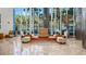 Expansive lobby with modern seating arrangements and towering windows framing tropical landscaping for an inviting ambiance at 175 1St S St # 3008, St Petersburg, FL 33701
