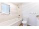 Bright bathroom features a shower and tub combination with white tiling at 2019 Inner S Cir, St Petersburg, FL 33712