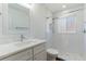 All-white bathroom offers a modern vanity, hexagon tile floor in the walk-in shower with a window at 2019 Inner S Cir, St Petersburg, FL 33712