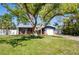 Charming single-Gathering home with a well-manicured lawn, mature trees, and inviting curb appeal at 2019 Inner S Cir, St Petersburg, FL 33712
