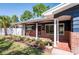 Charming front porch with rocking chairs and landscaped garden bed, perfect for relaxing outdoors at 2019 Inner S Cir, St Petersburg, FL 33712