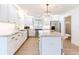 This spacious kitchen features white cabinets, stainless appliances, stone countertops, and a center island at 2019 Inner S Cir, St Petersburg, FL 33712