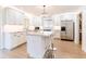 Bright kitchen featuring white cabinets, stainless appliances, stone countertops, and center island with seating at 2019 Inner S Cir, St Petersburg, FL 33712