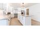 Bright kitchen featuring white cabinets, stainless appliances, stone countertops, and center island with drawers at 2019 Inner S Cir, St Petersburg, FL 33712