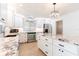 Bright kitchen featuring white cabinets, stainless appliances, stone countertops, and a center island at 2019 Inner S Cir, St Petersburg, FL 33712