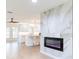 Modern living space with marble fireplace, tile floors, and open layout, connecting to the kitchen with island seating at 2019 Inner S Cir, St Petersburg, FL 33712