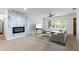 Bright living room features a marble accent wall, modern fireplace and large window with view of the yard at 2019 Inner S Cir, St Petersburg, FL 33712