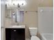 Well-lit bathroom featuring a vanity with a dark wood cabinet and a white toilet and tiled shower at 209 Lake Brook Cir # 104, Brandon, FL 33511