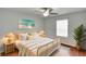 Cozy bedroom with a ceiling fan, a bright window, and a large bed and nightstands at 209 Lake Brook Cir # 104, Brandon, FL 33511