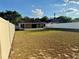 Wide backyard with green grass and privacy fence, featuring an enclosed patio for outdoor enjoyment at 224 Chardonnay Pl, Valrico, FL 33594