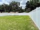 Expansive backyard enclosed by a white vinyl fence with well-maintained green lawn at 224 Chardonnay Pl, Valrico, FL 33594