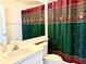 Bathroom with a colorful shower curtain, providing a cozy and functional space at 224 Chardonnay Pl, Valrico, FL 33594