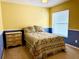 Bright bedroom featuring a floral patterned quilt, and a large window for natural light at 224 Chardonnay Pl, Valrico, FL 33594