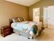 Comfortable bedroom with a cozy quilt, bedside table, and convenient access to the bathroom at 224 Chardonnay Pl, Valrico, FL 33594