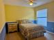 Bright bedroom with yellow and blue accents features a ceiling fan and comfortable furnishings at 224 Chardonnay Pl, Valrico, FL 33594
