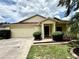Charming single-story home with a well-manicured lawn and attached two-car garage at 224 Chardonnay Pl, Valrico, FL 33594
