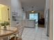 Bright eat-in kitchen features white cabinetry, modern appliances, and sliding glass door to the patio at 224 Chardonnay Pl, Valrico, FL 33594