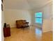 Bright living room features wood flooring, a large window, and a comfortable seating area at 224 Chardonnay Pl, Valrico, FL 33594