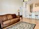 Open-concept living area with a comfortable leather couch, connecting seamlessly to the kitchen at 224 Chardonnay Pl, Valrico, FL 33594