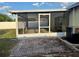 Enclosed patio featuring brick pavers, a ceiling fan, and easy access to the home's exterior at 224 Chardonnay Pl, Valrico, FL 33594