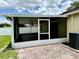 Covered patio with brick flooring, screened enclosure, and access to a large backyard at 224 Chardonnay Pl, Valrico, FL 33594