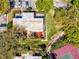 Aerial view of the home, showcasing the patio, greenery, tennis courts, and swimming pool at 2644 2Nd Ct, Palm Harbor, FL 34684
