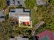 Aerial view of the home, showcasing the patio, surrounding greenery, and nearby tennis courts at 2644 2Nd Ct, Palm Harbor, FL 34684