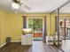 Bright bedroom features wood-look floors, light yellow walls, and balcony access at 2644 2Nd Ct, Palm Harbor, FL 34684