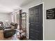 Welcoming entryway featuring a sleek black door and modern decor, leading to a bright living space at 2644 2Nd Ct, Palm Harbor, FL 34684