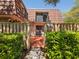 Charming home with a wooden fence, lush greenery, and a welcoming entrance at 2644 2Nd Ct, Palm Harbor, FL 34684