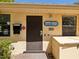 Exterior of the condo featuring a brown door and sign at 2644 2Nd Ct, Palm Harbor, FL 34684