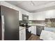 Modern kitchen featuring stainless steel appliances, granite countertops, and sleek white cabinetry at 2644 2Nd Ct, Palm Harbor, FL 34684