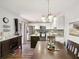 Well-lit kitchen with white cabinets, stainless steel appliances, and an inviting dining area at 2644 2Nd Ct, Palm Harbor, FL 34684