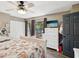 Bright main bedroom features a ceiling fan, wood-look floors, and a balcony with views at 2644 2Nd Ct, Palm Harbor, FL 34684