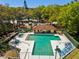 Aerial view of the community pool and spa area with plenty of space for lounging at 2644 2Nd Ct, Palm Harbor, FL 34684