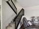 A carpeted staircase features dark wood railings, providing a stylish transition between levels in the home at 2644 2Nd Ct, Palm Harbor, FL 34684