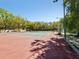 View of the tennis court and perimeter fencing at 2644 2Nd Ct, Palm Harbor, FL 34684