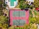 Overhead view showcasing the community tennis courts and the surrounding green landscape at 2644 2Nd Ct, Palm Harbor, FL 34684
