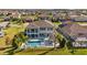 High-angle shot capturing a home's backyard featuring a swimming pool, cozy patio, and lush yard in a neighborhood at 28355 Picana, Wesley Chapel, FL 33543