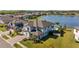Expansive aerial shot showcasing a large home with a brick driveway and a lush, green lawn near a serene lake at 28355 Picana, Wesley Chapel, FL 33543