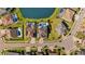 Aerial view of the neighborhood with multiple homes, landscaped lawns, driveways, and a pond at 28355 Picana, Wesley Chapel, FL 33543