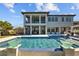 Expansive backyard featuring a pool, spa, and covered patio, creating an entertainer's paradise at 28355 Picana, Wesley Chapel, FL 33543