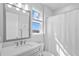 Bathroom with modern vanity, bright mirror, and a shower/tub combo at 28355 Picana, Wesley Chapel, FL 33543