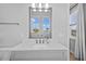 A bright bathroom with a modern vanity, large mirror, and a window at 28355 Picana, Wesley Chapel, FL 33543