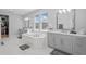 Bathroom featuring a soaking tub, dual sinks, and ample natural light at 28355 Picana, Wesley Chapel, FL 33543