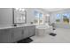 Bright bathroom with a soaking tub, double vanity, and serene water views at 28355 Picana, Wesley Chapel, FL 33543