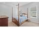 Traditional bedroom features a four-poster bed, neutral walls, and carpeted floors at 28355 Picana, Wesley Chapel, FL 33543