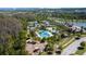 Aerial image of community amenities including swimming pool, tennis courts, lake, and playground at 28355 Picana, Wesley Chapel, FL 33543